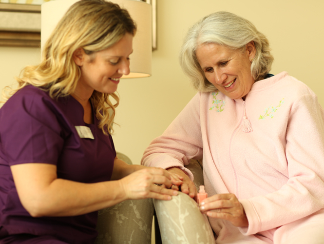 a healthcare worker helping an elderly woman