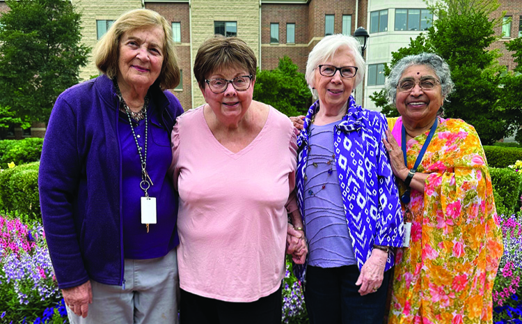 four elderly women smiling