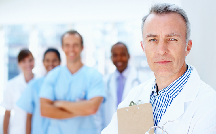 a doctor with workers behind him