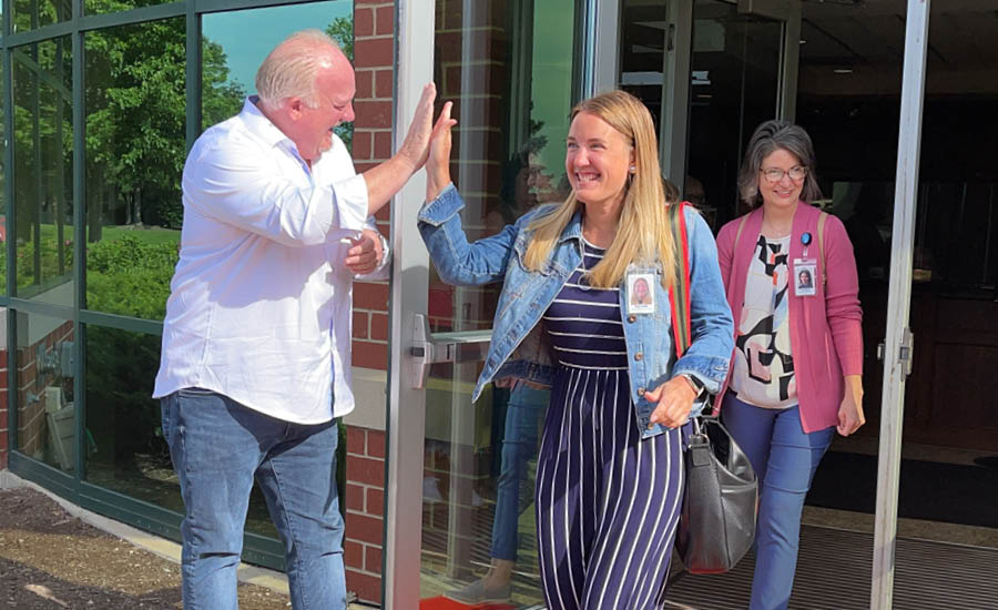 a woman giving an older man a high five