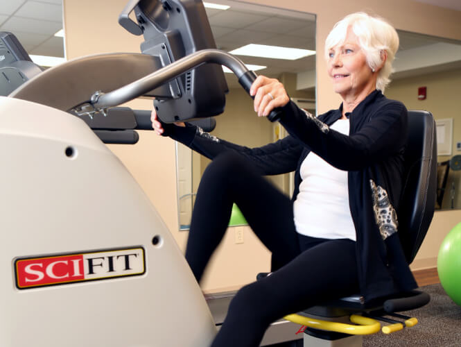 an active senior woman on exercise bike at victorian village